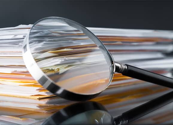 Stock-Photo-Magnifying-Glass-and-Files